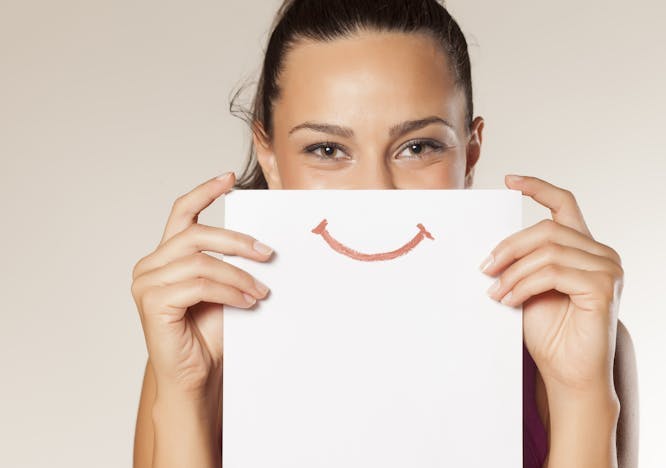 happy smile woman face paper card white showing person girl portrait beautiful holding isolated sign female fun hand cheerful communication expression sheet advertising smiley young happiness people attractive funny looking message presentation advertisement emoticon positive smiling emotion friendly human necklace accessories jewelry accessory skin text finger