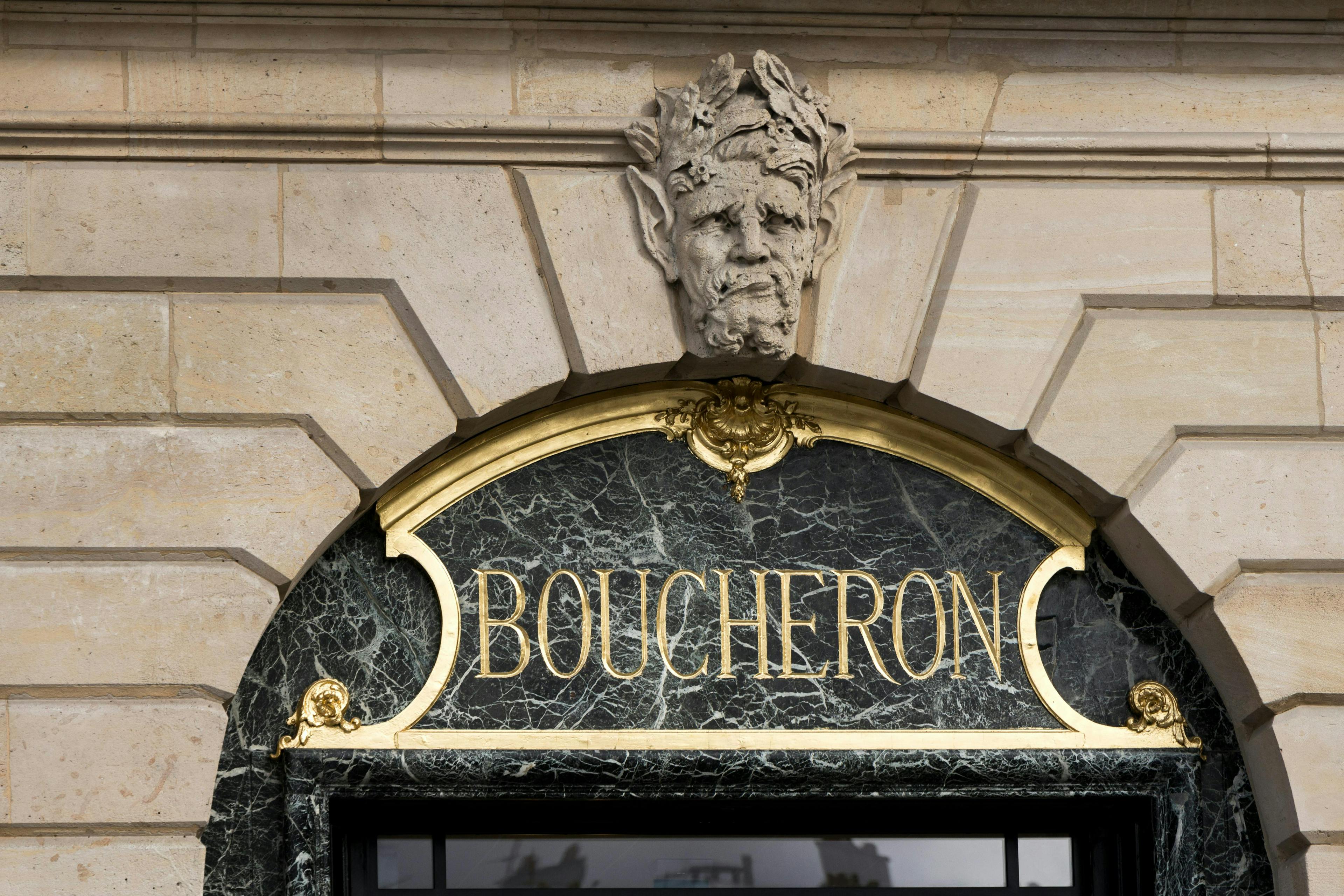 jewelry,symbol,city,icon,sign,store,urban,street,logo,text,emblem,europe,word,french,boucheron architecture building monastery arch person logo face head