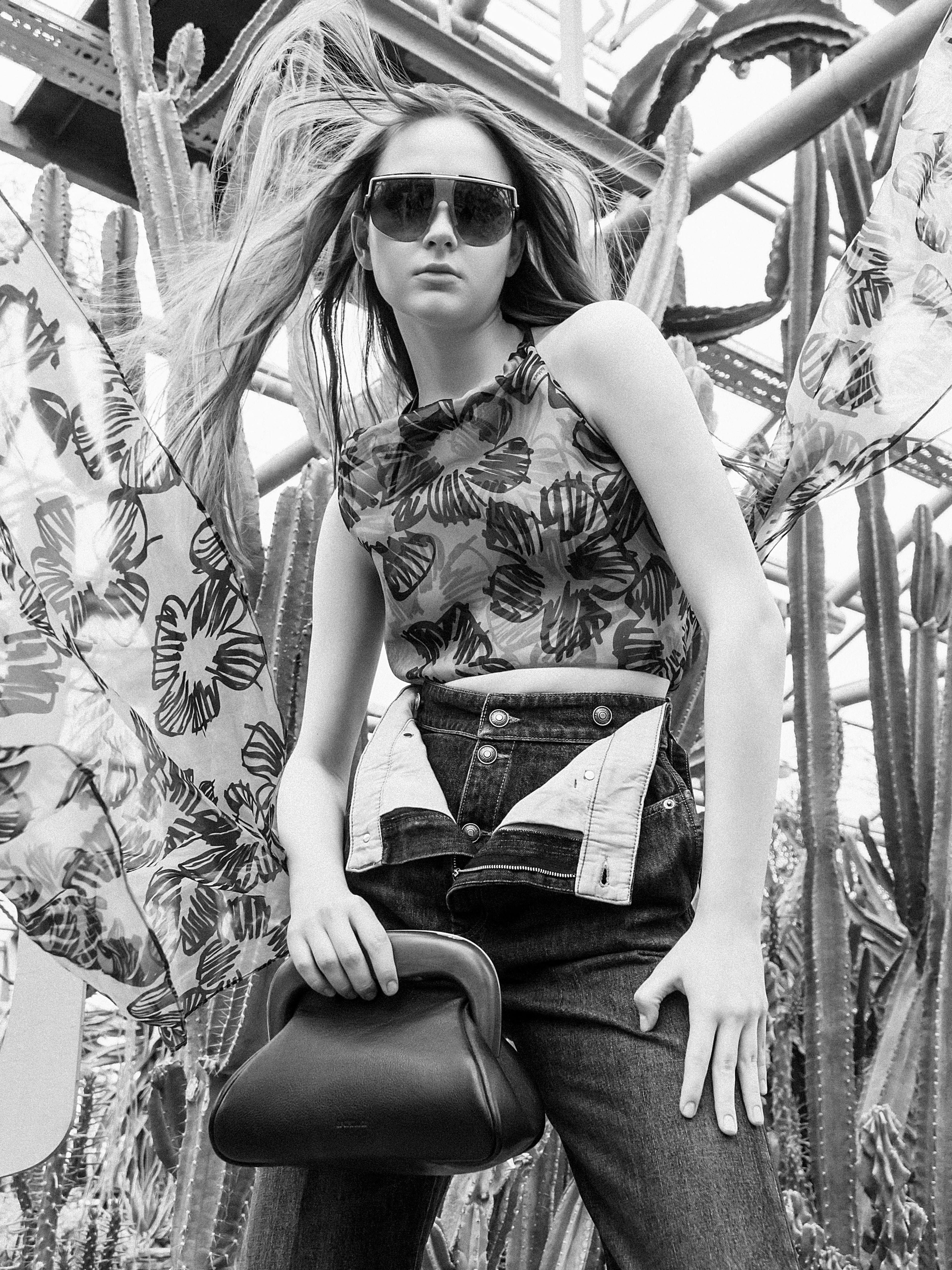 clothing pants accessories sunglasses bag handbag person portrait purse jeans